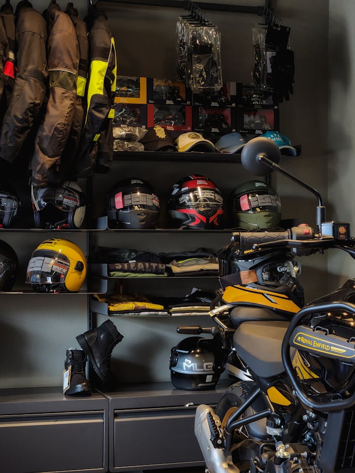 services-03 A collection of motorcycle gear including helmets and jackets in a showroom setting.